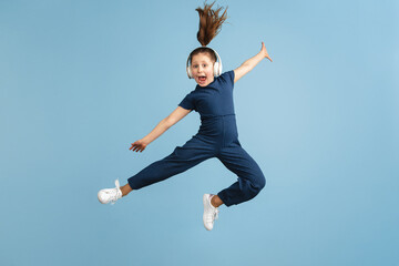 Pretty caucasian girl portrait isolated on blue studio background with copyspace