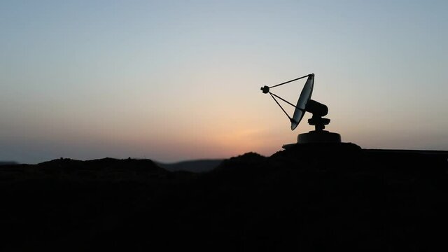 Space radar antenna on sunset. Silhouettes of satellite dishes or radio antennas against night sky. Creative artwork decoration. Selective focus