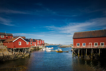 Obraz premium Traditional Norwegian houses near the lake. Fishing village. Wooden houses. Lofoten Islands, Norway