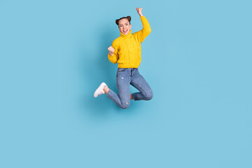 Fototapeta na wymiar Full length body size view of attractive cheerful girl jumping rejoicing isolated over vibrant blue color background