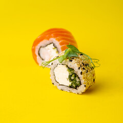 Closeup of delicious japanese food with sushi roll on yellow background.