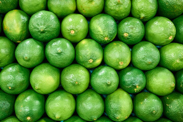 Fresh Organic Green Limes Stacked in Grocery Store