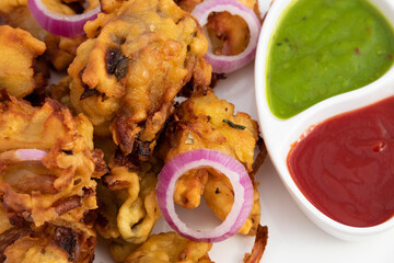 Deep Fried Crispy Indian Street Food With Various Names Like Onion Bhajji Pyaj Pakora Or Pakore Pyaaj Ke Pakode Or Pakoda Kanda Bhaji Pyaaz Bajji Served With Chutney And Sauce Is Tea Time Chaat Snacks