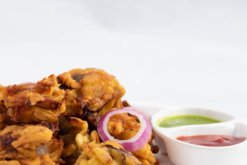 Delicious Crispy Indian Street Food With Various Names Like Onion Bhajji Pyaj Pakora Or Pakore Pyaaj Ke Pakode Or Pakoda Kanda Bhaji Pyaaz Bajji Served With Chutney And Sauce Is Tea Time Chaat Snacks