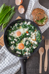 Shakshouka - Middle eastern traditional dish with poached eggs and wild garlic