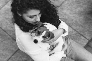 Girl with a dog sitting on a bench in summer