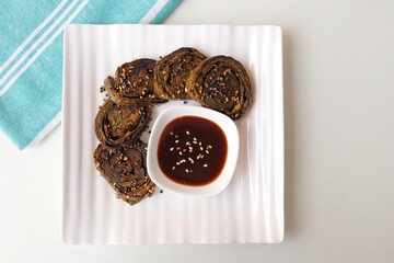 Alu Vadi, Patra, paatra, colocasia leaves roll, Patrode is a popular Indian healthy steamed snack. Garnished with sesame and mustard seeds. served with tamarind chutney. copy space.