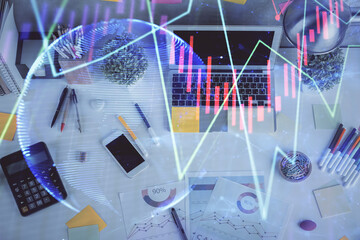 Double exposure of forex chart drawing over table background with computer. Concept of financial research and analysis. Top view.