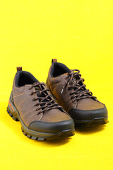 Stylish leather sneakers in isolation, on a yellow background. High quality photo