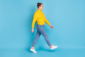 Fototapeta na wymiar Full body profile portrait of pretty person walking look empty space wear pullover isolated on blue color background