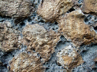 Rough and rough texture of the stone with depressions on the surface