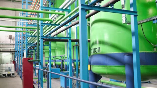 Green chemical tanks, huge barrels of chemicals, polyol containers. Translation of the inscription: "Polyol"