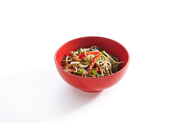 Udon noodle with teriyaki chicken and vegetable. Asian style noodle food on white background. Teriyaki chicken noodle in red bowl with sesame and onion.