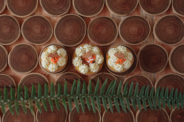 dessert, cheesecake with mango and passion fruit in the form of brownies with mousse on top. Decorated with cookies in the form of a heart. On a wooden table in a white plate