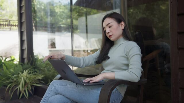 Young Asian woman sitting in a cafe weary work and bored.