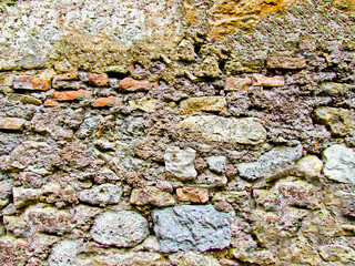 Background texture of an antique stone wall close-up