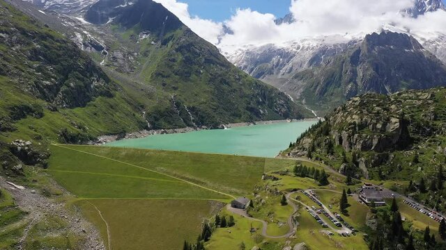 Aerial footage of the Goscheneralp lake and dam near Andermatt in Canton Uri in the alps in Switzerland with a rotation revealing motion