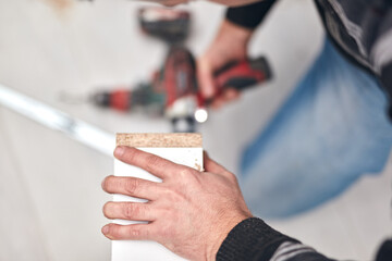 Handyman worker assembling furniture and fixing it.