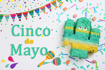 Obraz premium Cinco de Mayo festive poster. Bright funny pinata on light background, flat lay