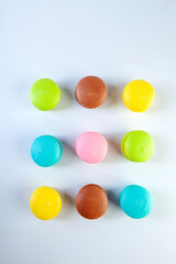 colored fresh macarons in studio on white background