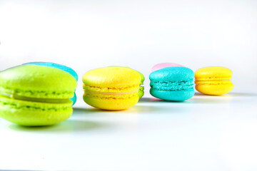 colored fresh macarons in studio on white background