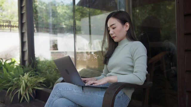 Young Asian woman sitting in a cafe weary work and bored.
