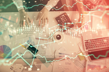 Double exposure of man and woman working together and financial chart hologram drawing. market analysis concept. Computer background. Top View.