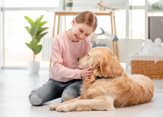Little girl with golden retriever dog