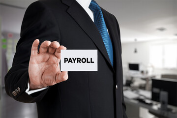 Businessman shows a business card with the word payroll. Business finance