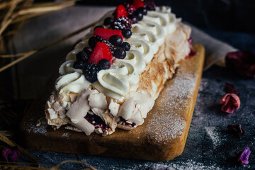 Meringue roll with berries. Delicious meringue roll on the table 