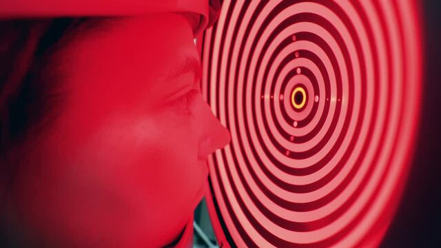 Woman's eyesight is getting checked by a biometer