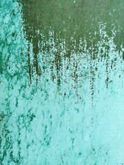 old green metal wall torn in blue