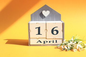 Calendar for April 16: cubes with the numbers 0 and 16, the name of the month of April in English,...