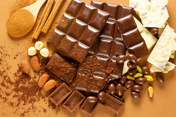 White and milk chocolates. Almond, pistachio, hazelnut.. background, texture..
