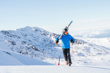 Ski. Skier. Skier walking on the snowy mountain. Skier walking in the snow. Snowy mountain. High mountain. Extreme sports. Sierra Nevada