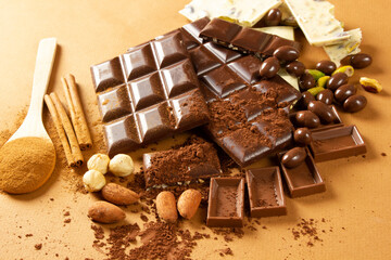 White and milk chocolates. Almond, pistachio, hazelnut.. background, texture..