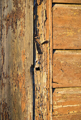 Old wall of wooden planks with paint cracked .