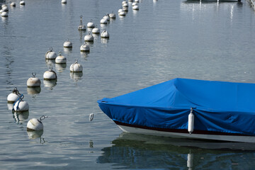 boats and yachts with a tarpaulin anchored in Lake Geneva Switzerland