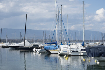 Naklejka na ściany i meble boats and yachts with a tarpaulin anchored in Lake Geneva Switzerland