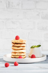 Obraz na płótnie Canvas Stack of ricotta-pancake with raspberries, honey 
