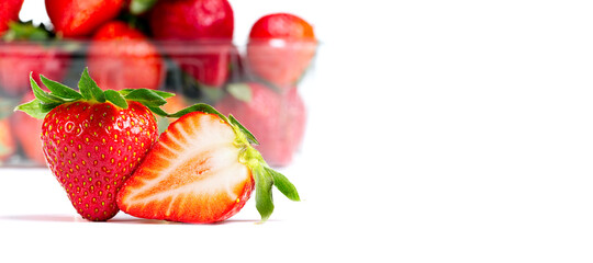Greece Strawberries isolated on a white background. Fresh organic ripe Spain strawberry with plastic tray on background, close-up