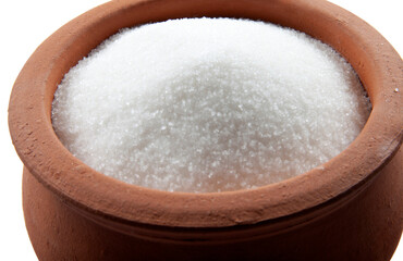 Fototapeta na wymiar Granulated sugar in bowl. Crystals of refined table sugar. Sweet soluble carbohydrates. Sucrose, disaccharide of glucose and fructose.