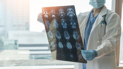 Brain disease diagnosis with medical doctor seeing Magnetic Resonance Imaging (MRI) film diagnosing...
