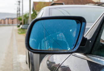 Novi Sad, Serbia - April 06. 2021: Rear-view mirror of an Audi vehicle, parked in front of a private property. 