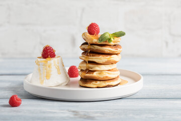 Stack of ricotta-pancake with raspberries, honey 