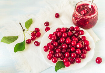 Sweet cherry in a plate.Fresh cherries in jar for Homemade preserved cherry jam. Top view.Space for text.