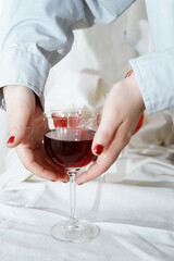 Red wine aesthetic. Womans hand. 