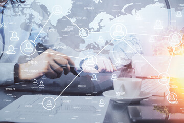 Double exposure of man's hands holding and using a phone and social network theme drawing.