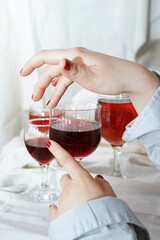 Red wine aesthetic. Womans hand. 