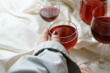 Red wine aesthetic. Womans hand.